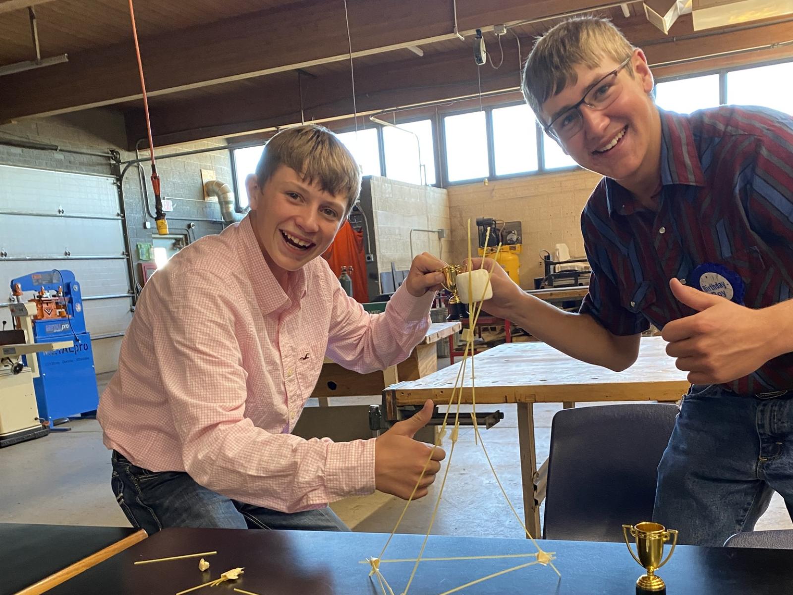 2 students building a structure 