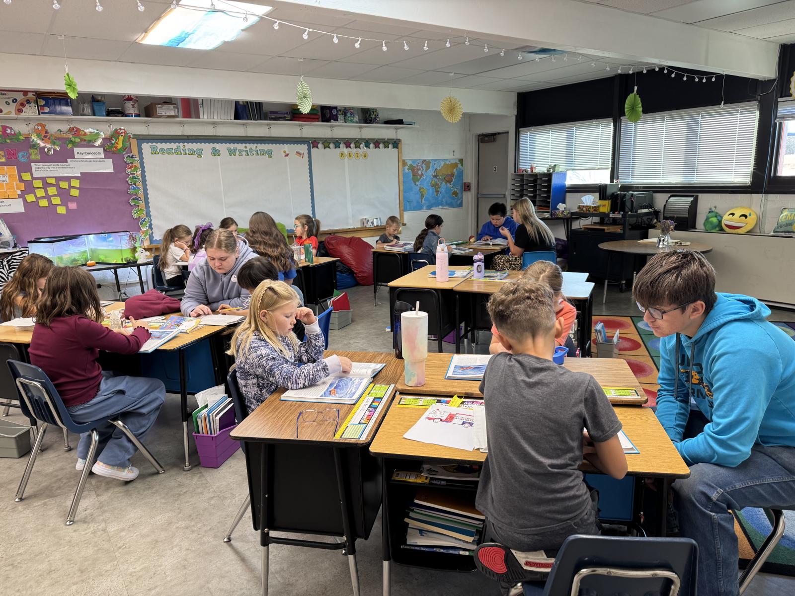 Students looking at books in classroom