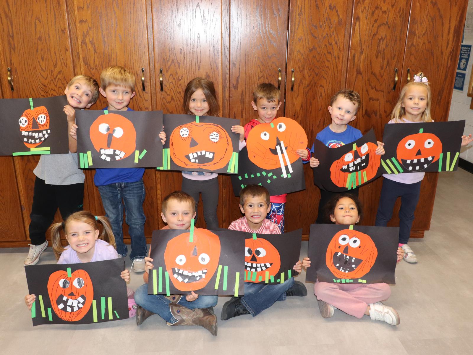 Students holding their pumpkin art