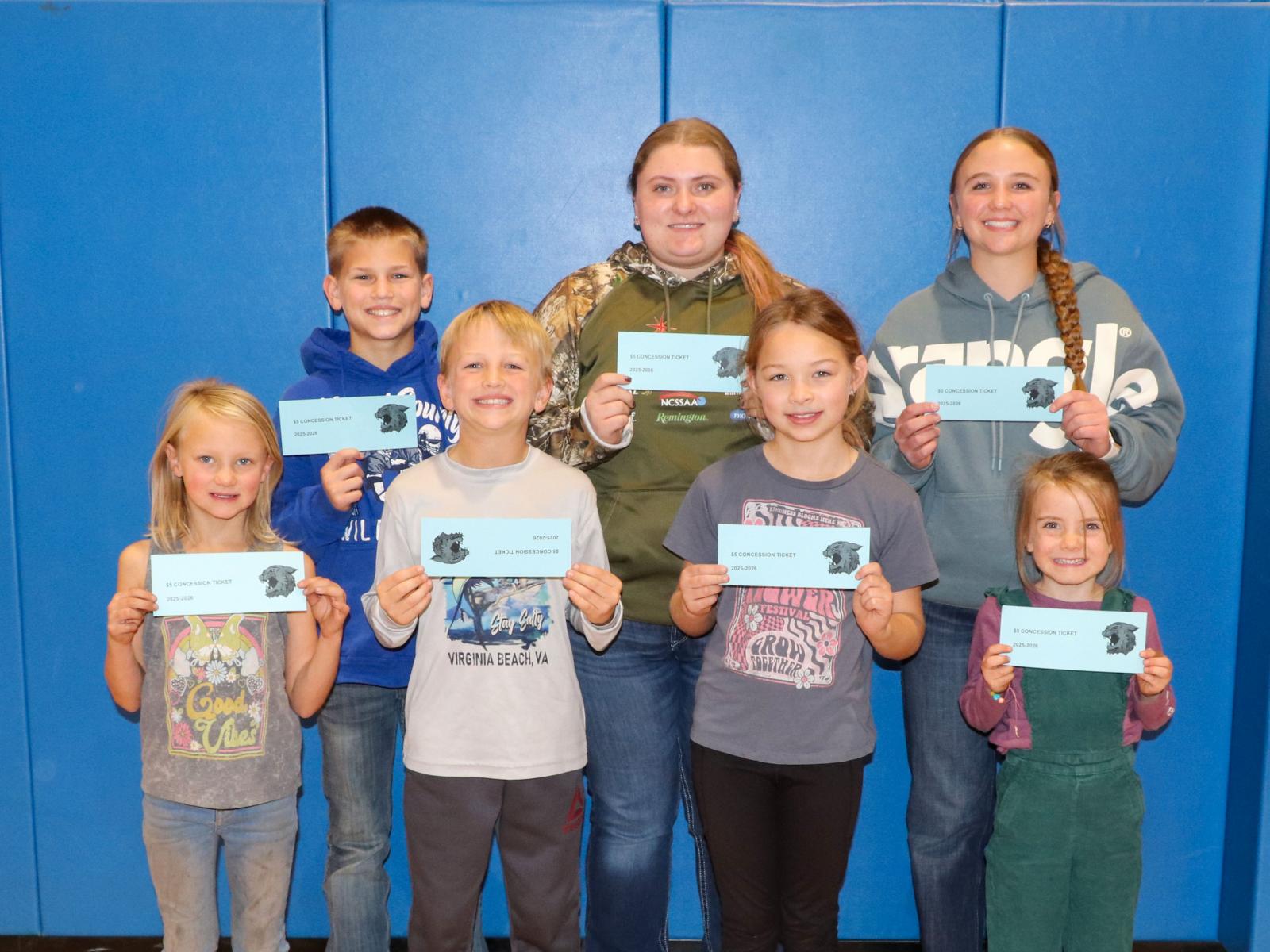 Students holding prizes for being students of the month