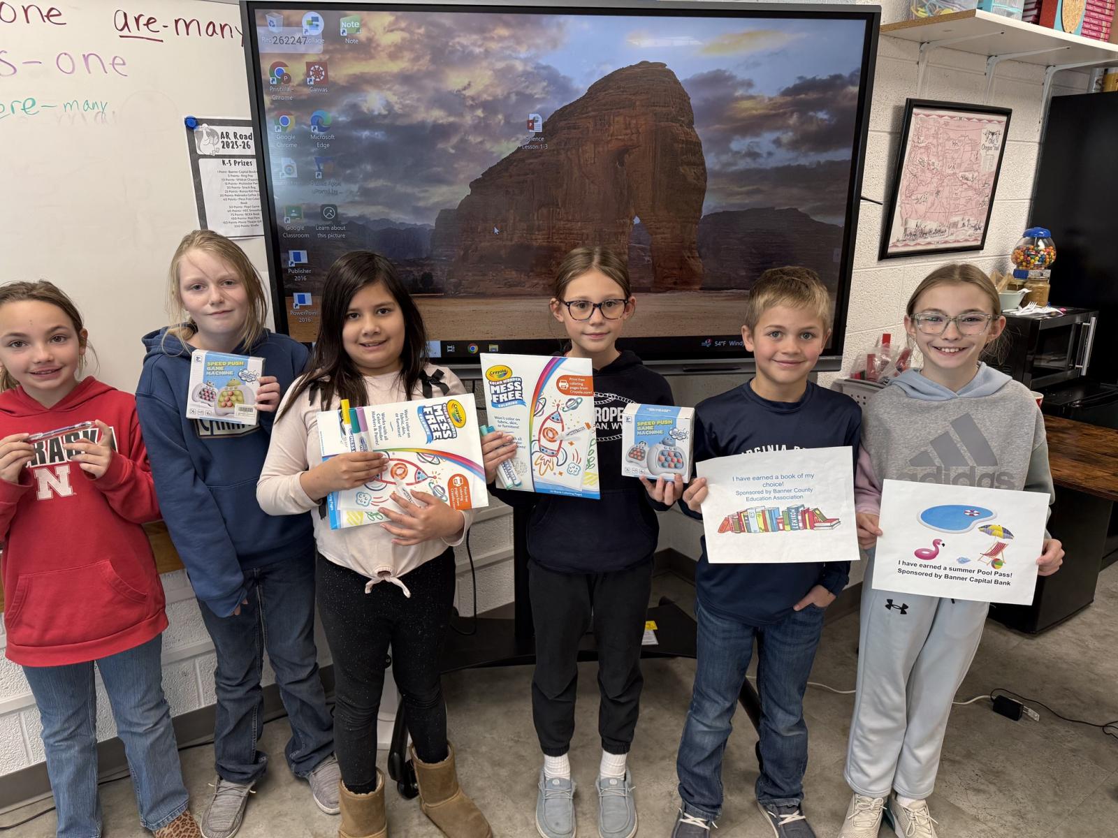 Students holding prizes for  reading 