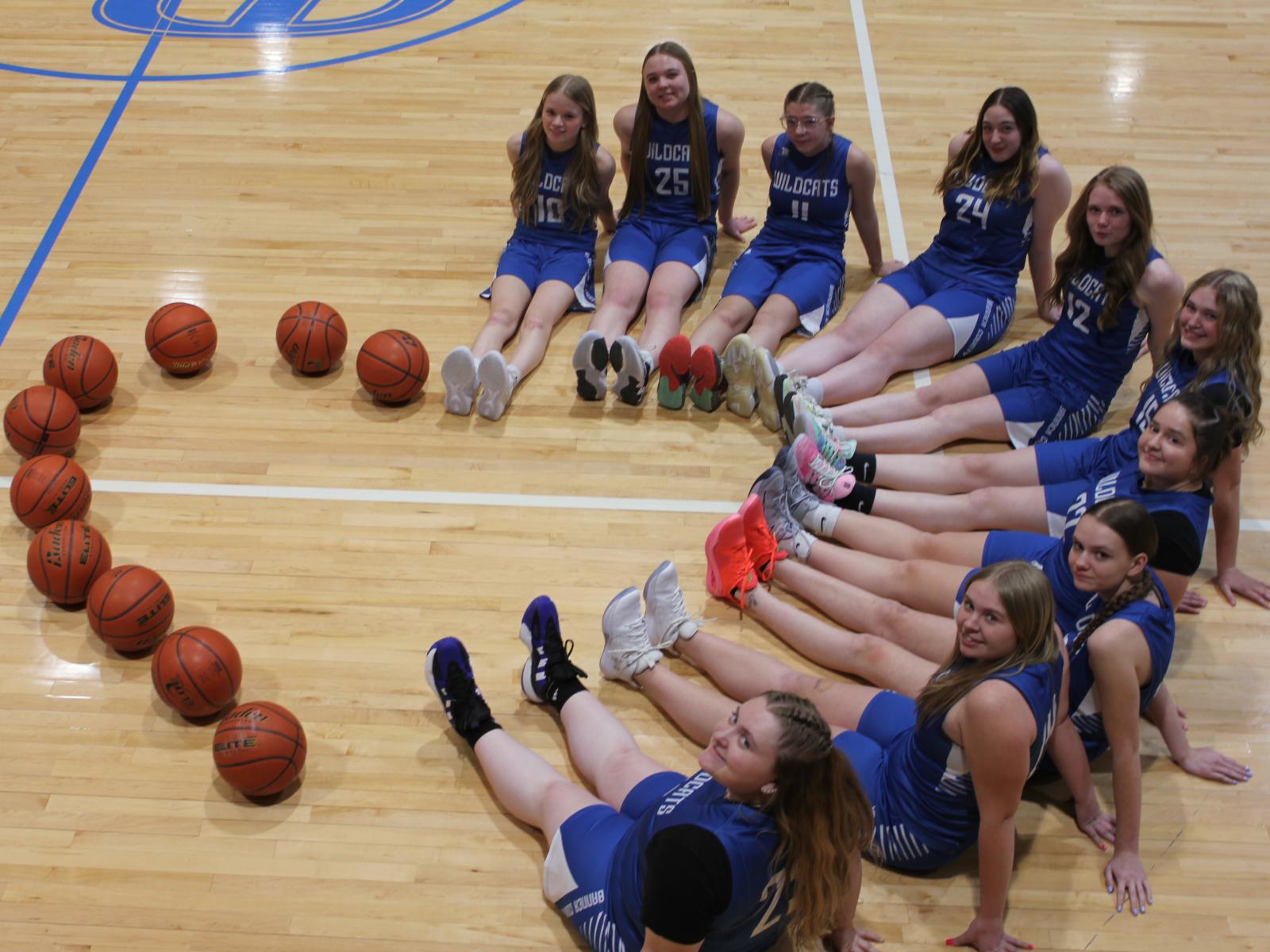 Girls basketball players in a heart shaped